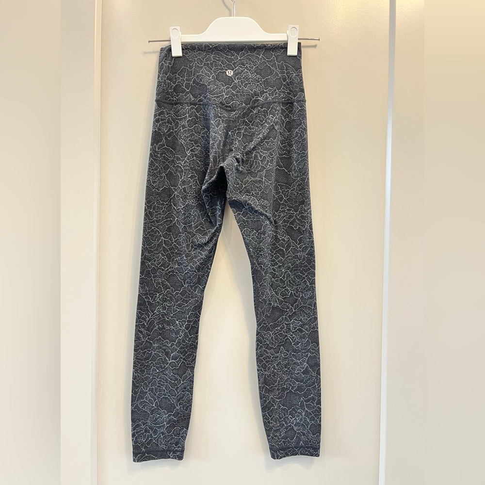 Lululemon Women’s black leggings with delicate floral design EUC 26” Inseam